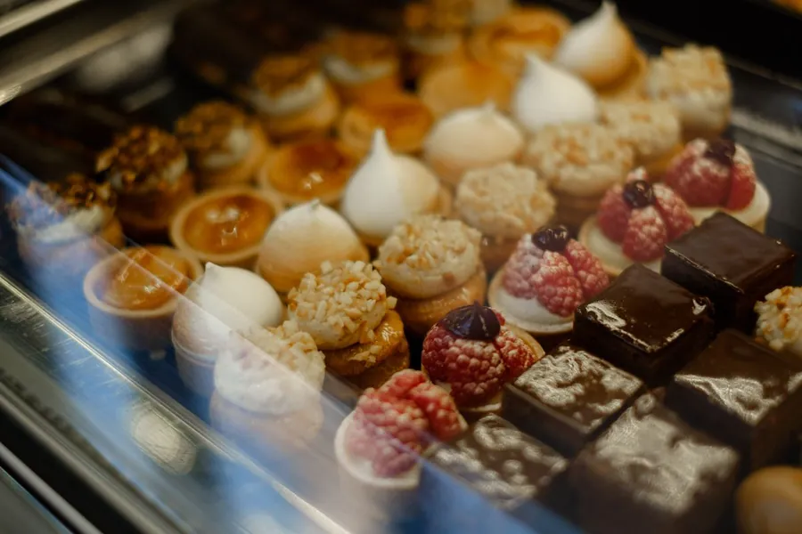 Display case of small tarts, pastries and chocolates