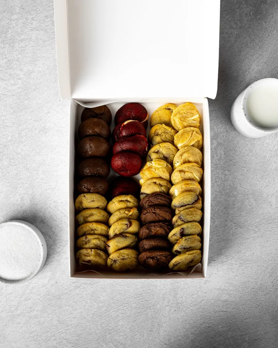 Open white box filled with assorted cookies